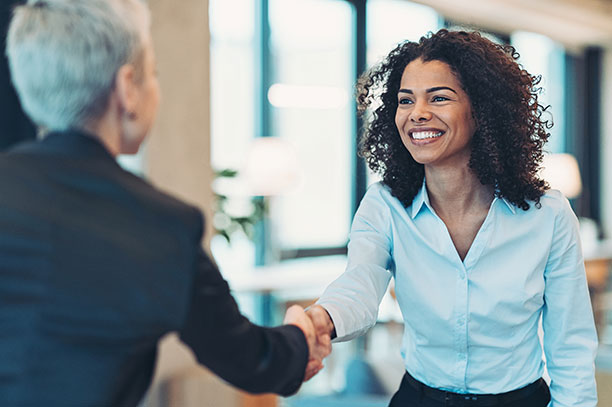 Two women shaking hands
