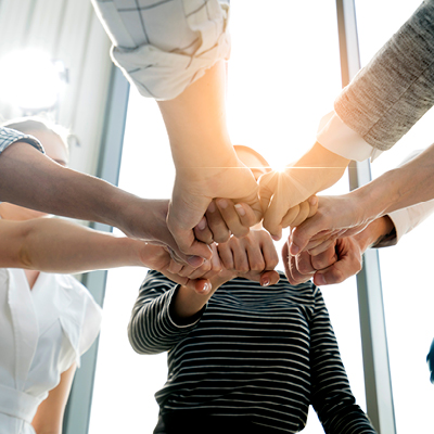 team members with fist in a circle