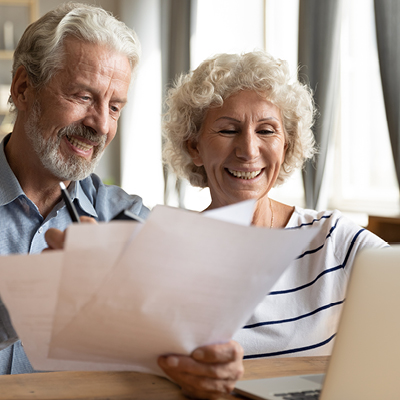 Elderly couple at a table looking at papers