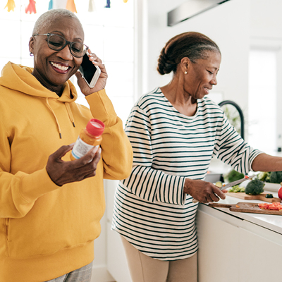 african american woman on the phone looking at a bottle