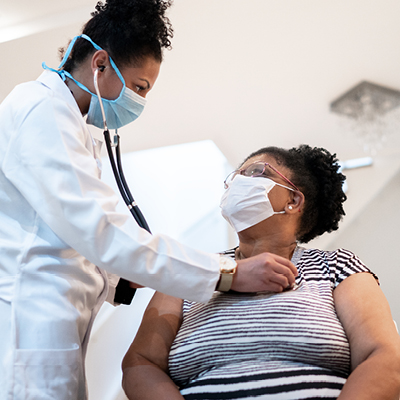 Physician using a stethoscope on a patient