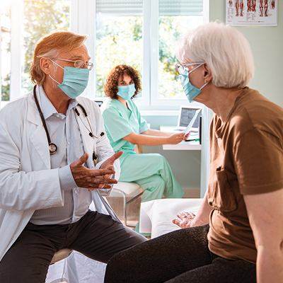 Older women at a doctors office speaking with physician