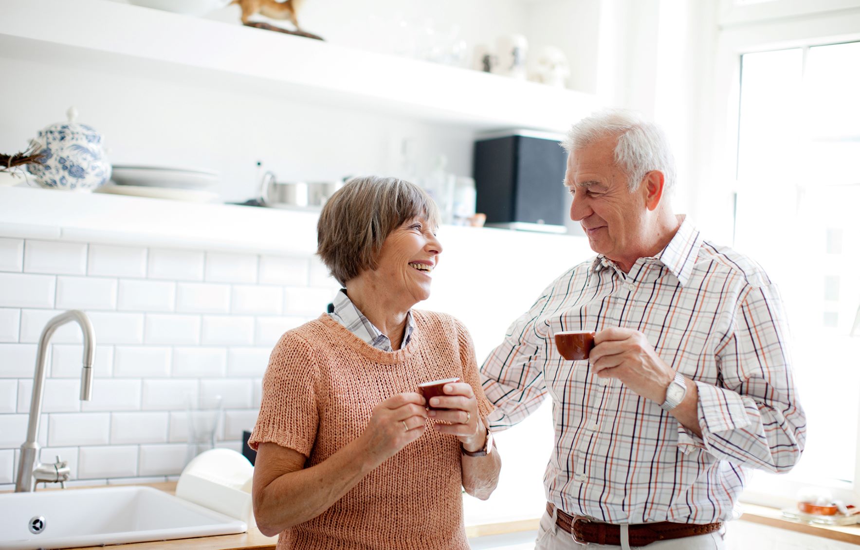 Older couple standing in kitchen