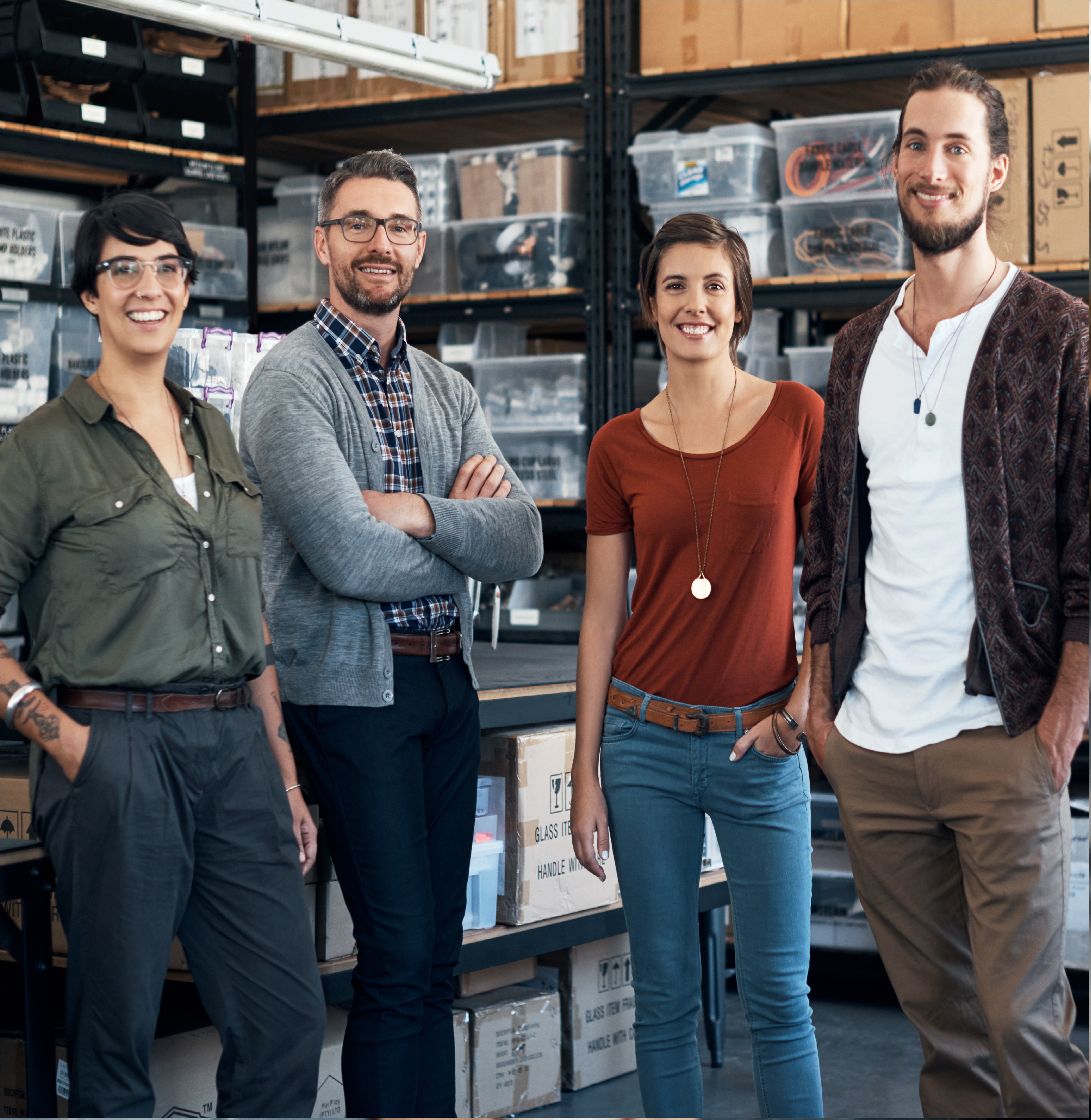 4 people standing in a warehouse