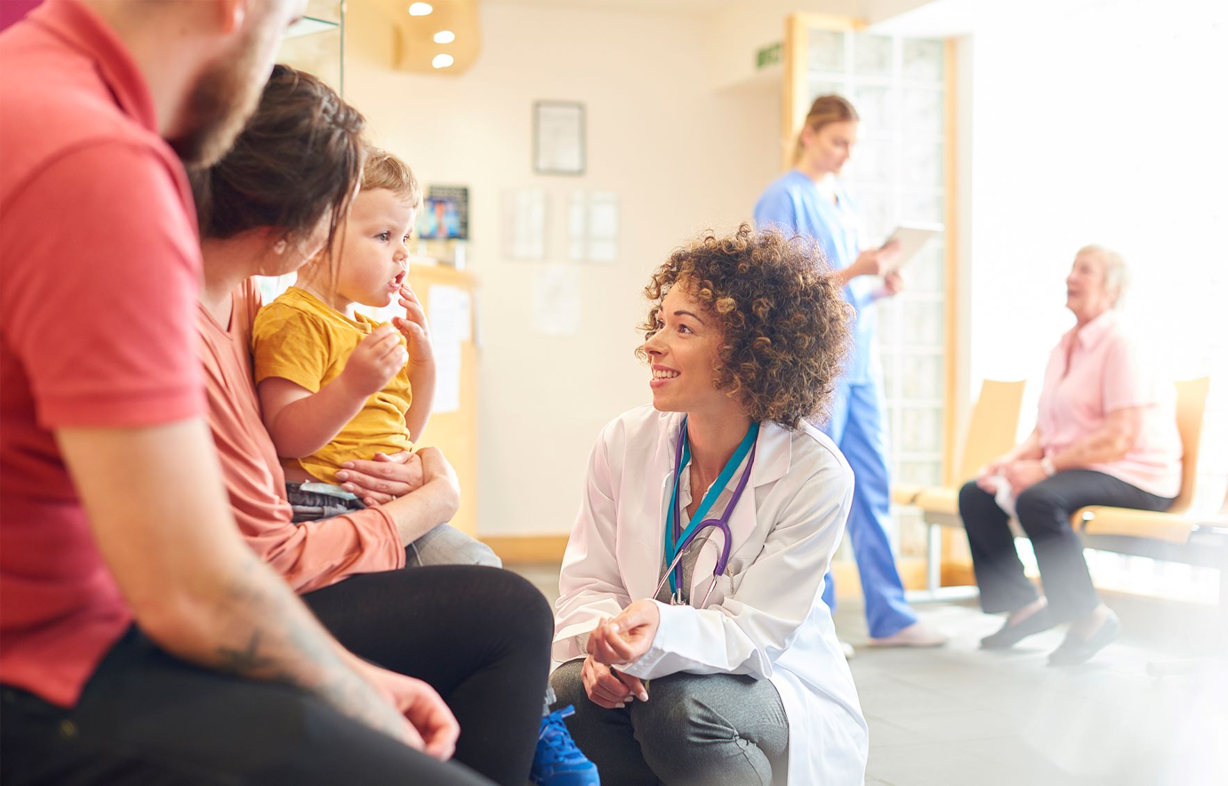 Doctor talking to child and parents