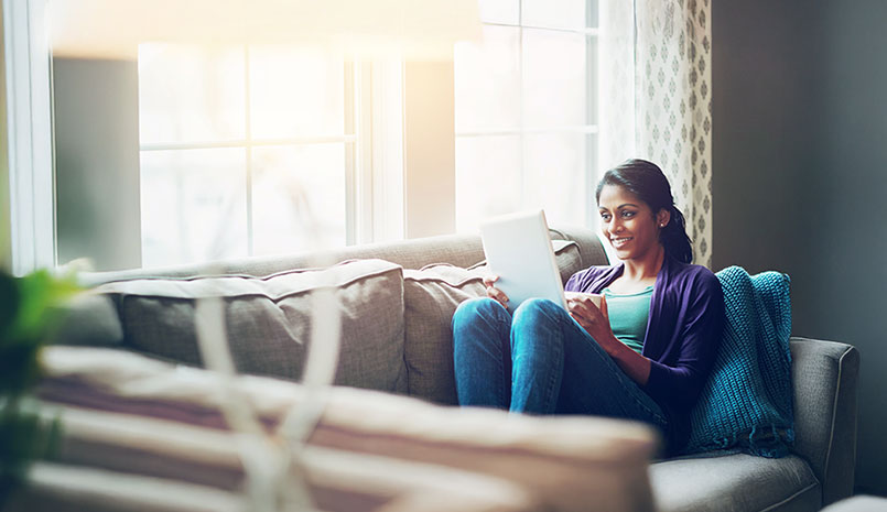 Woman sitting on couch reading