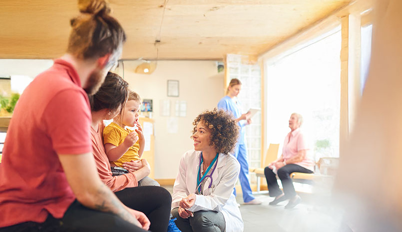 Doctor talking to child and parents